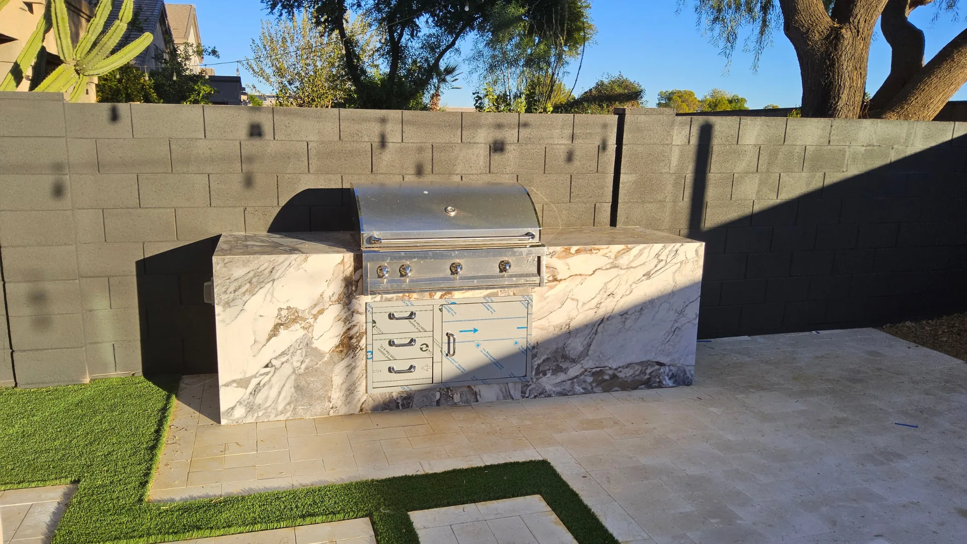 Marble-counter grill island with stainless doors and drawers