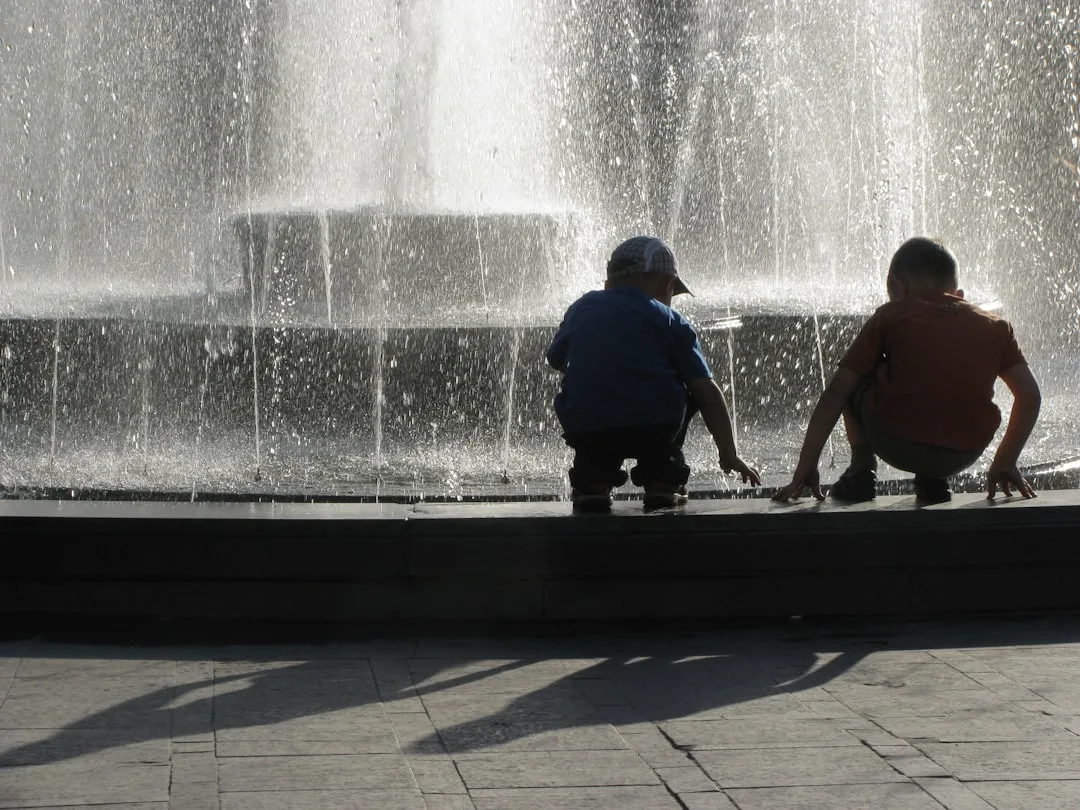 Family relaxing near a water fountain